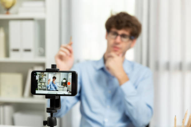 istock Host channel of influencer using smartphone blurred image focusing face. Gusher. 1980430344