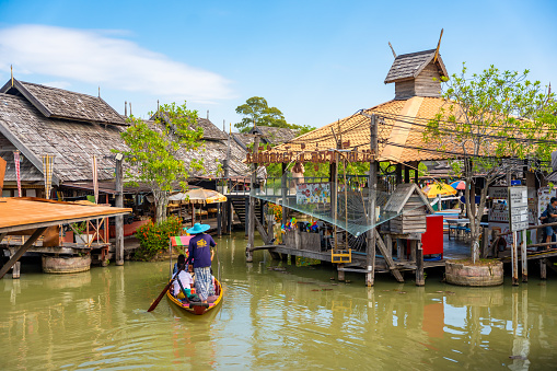 Pattaya, Thailand - December 29, 2023: Floating open air market with small houses - shops on the pond in Pattaya, Thailand. High quality photo