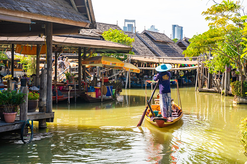 Pattaya, Thailand - December 29, 2023: Floating open air market with small houses - shops on the pond in Pattaya, Thailand. High quality photo