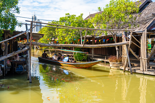 Pattaya, Thailand - December 29, 2023: Floating open air market with small houses - shops on the pond in Pattaya, Thailand. High quality photo