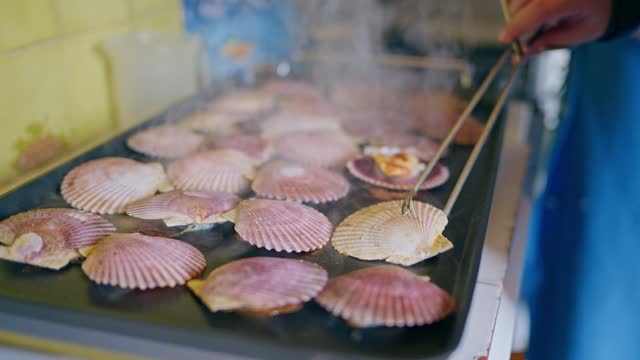 Close-up of a Man Cooking Scallops on a Grill