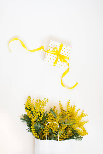 istock Yellow mimosa flowers frame with gift box. Womans day, easter , spring composition. Top view with copy space 1980452411