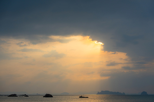 Dramatic sky over the bay of water at sunset in Krabi, Thailand