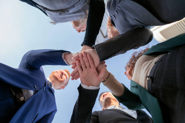 istock hands together doing business people team point of view below 1980510908