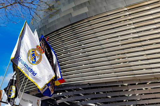 Madrid, Spain. Real Madrid flags for sale waving at street stalls near the stadium on match day.