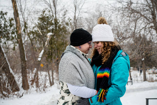 istock winter love: Trans Women's Affectionate Bond in the Snow 1980525003