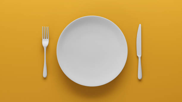 istock Top view of Empty white ceramic plate set on yellow, 3D render 1980533360