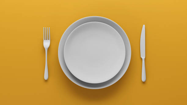 istock Top view of Empty two white ceramic plate set on yellow, 3D render 1980533875