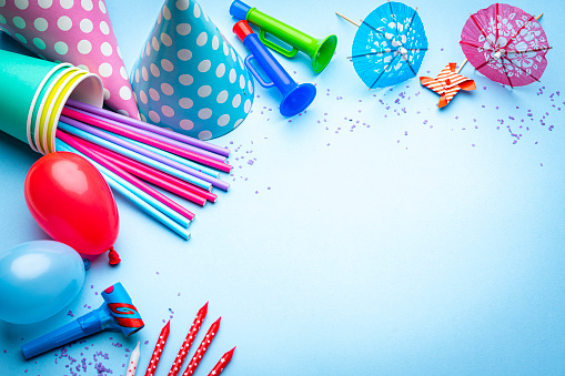 Birthday party or carnival accessories on blue background. Copy space
