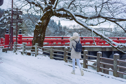 Beautiful woman tourists enjoying their trip to Takayama village with thick snow Japan at winter