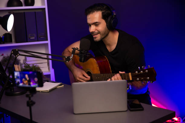istock Influencer creative audio on live streaming with sing with play guitar. Surmise. 1980552611