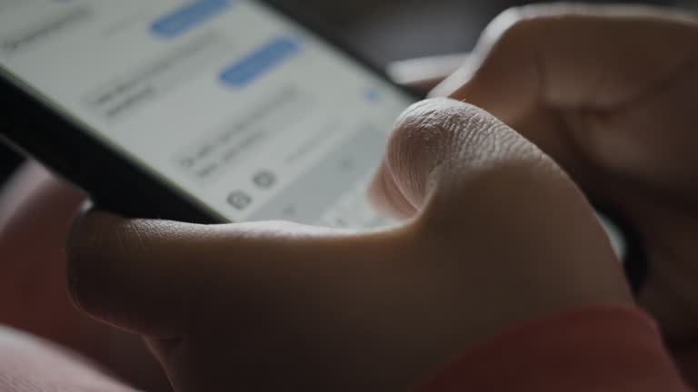 Close-up of Child's Hands Typing in Messaging App on Smartphone