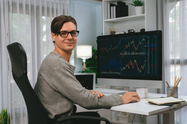 istock Trader in casual looking at camera against stock exchange. Pecuniary. 1980599742