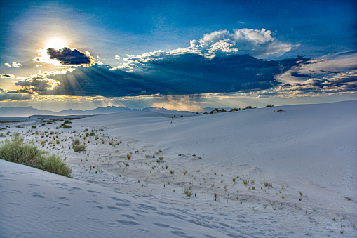 White Sands National Monument Sunset and clouds with distant rainstorm at the mountains