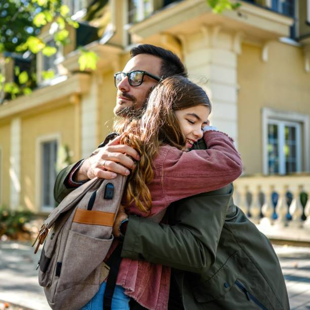istock Daughter hugging her father after school 1980700434