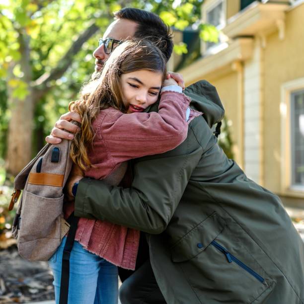 istock Daughter hugging her father after school 1980708194