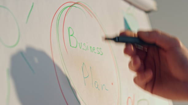 istock Hand showing flip chart business plan in office closeup. Worker presenting ideas 1980716551