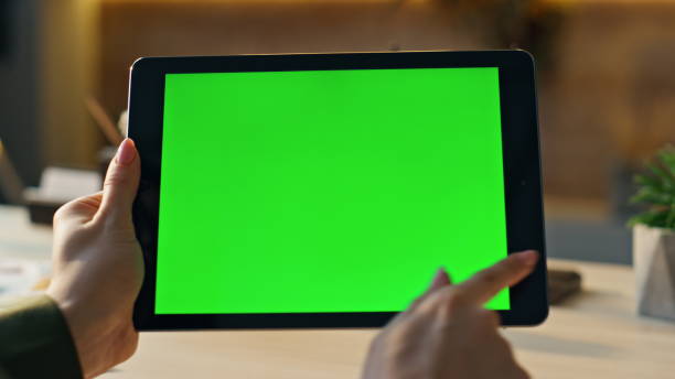 istock Woman hands swiping mockup tablet at workplace closeup. Manager using chroma key 1980747309
