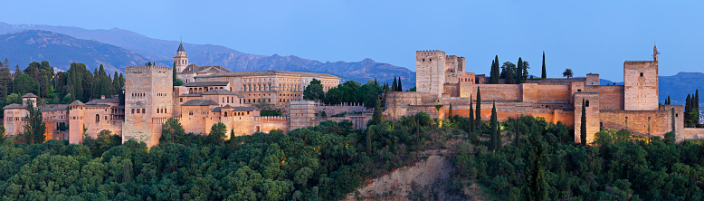 Granada, Spain - May 1, 2023: Panoramic view of the Alhambra at dusk (Granada, Spain).