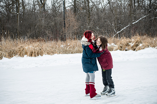 In a tender winter moment, the trans teen finds balance and support, holding on to his mentor in a heartfelt hug, an embrace that transcends the chill of the season.