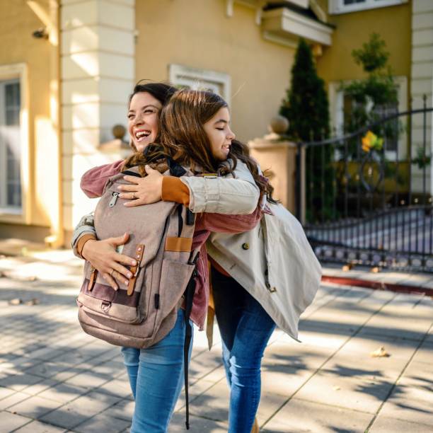 istock Daughter hugging her mother after school 1980794897
