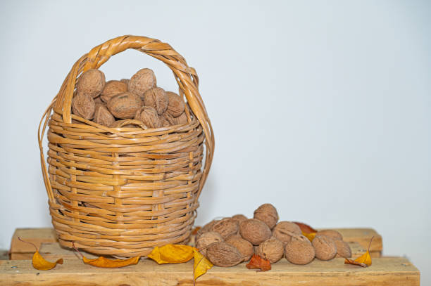 Pecans in and out of a basket.