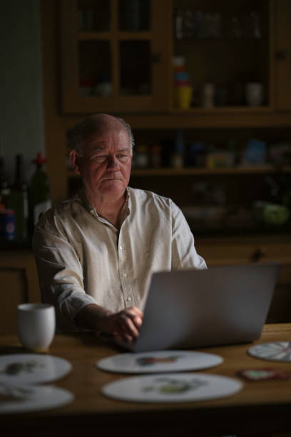 istock Senior man working on his computer at home 1980806059