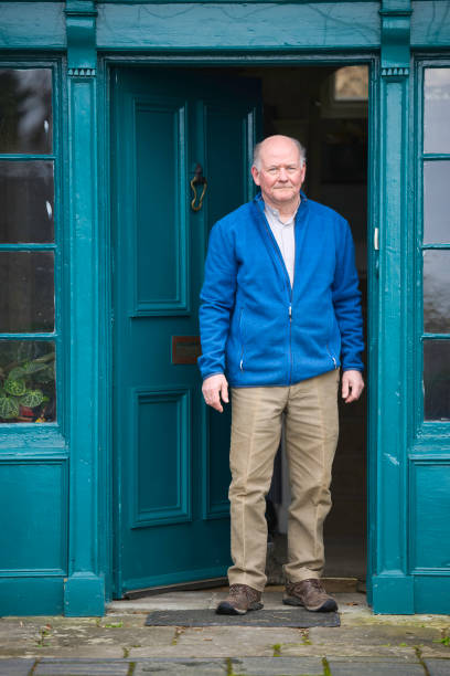 istock Senior man standing by his front door 1980810271