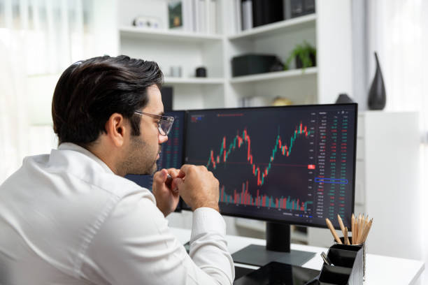 istock Trader analyzing in dynamic stock exchange investment screen on pc. Surmise. 1980812866