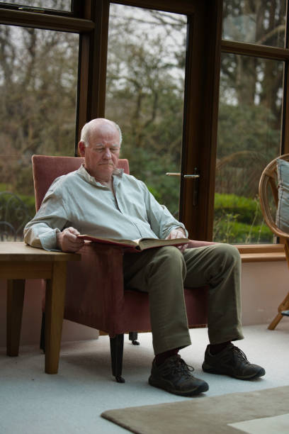 istock Retiree reading in his conservatory 1980817071