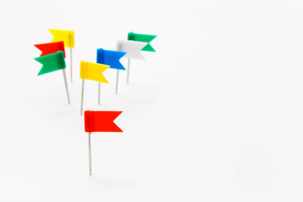 istock Red thumbtack shaped like a flag leading a group with different colors 1980817610