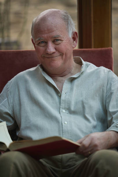 Retiree reading in his conservatory