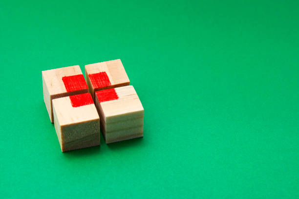 Wooden cube puzzle forming a red square in its center with a green background