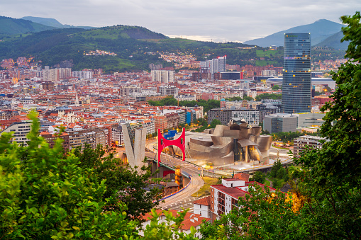 Bilbao, Spain - July 1, 2023: High Angle View on the Guggenheim Museum and Skyline of Bilbao, Spanish Basque Country, Spain around sunset. The Guggenheim Museum Bilbao is a museum of modern and contemporary art and was inaugurated in 1997. It is one of the largest museums in Spain.