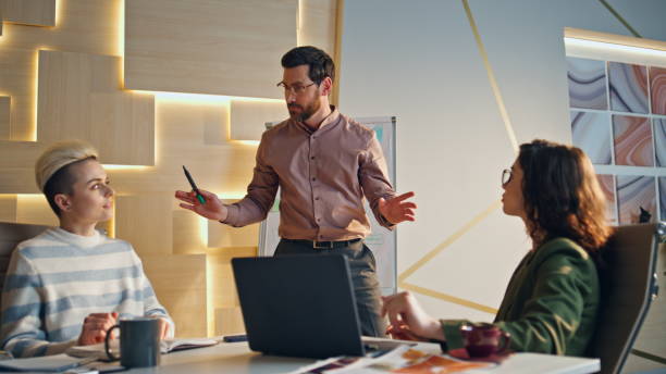 istock Professional manager finish speech in coworking place. Happy team clapping hands 1980855976