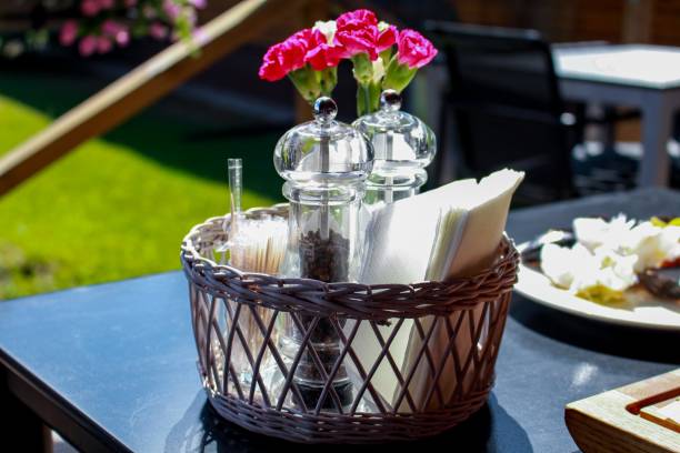 istock Salt and Pepper. Red Flowers In Vase. Restaurant Table. 1980869407