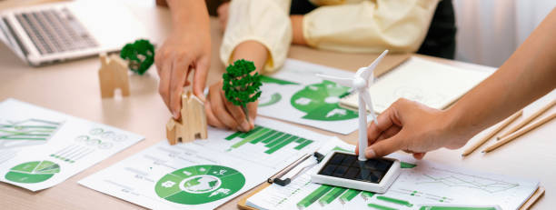 istock Windmill model placed during presenting green business. Closeup. Delineation. 1980869734