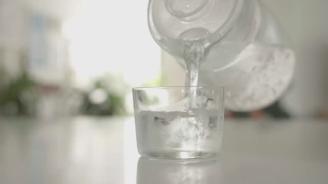 Refreshing Hydration: Pouring Cold Water into a Glass