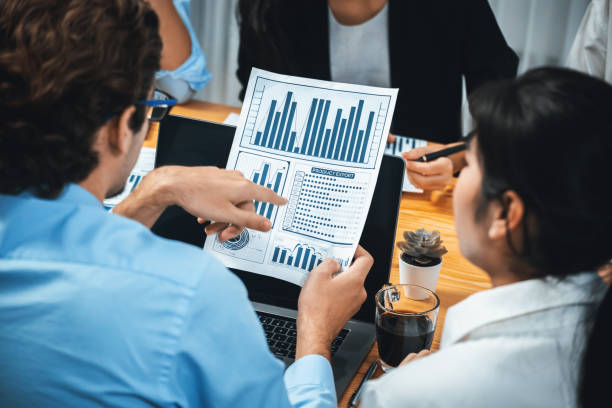 istock Group of business analyst team analyzing financial data report. Habiliment 1980912799