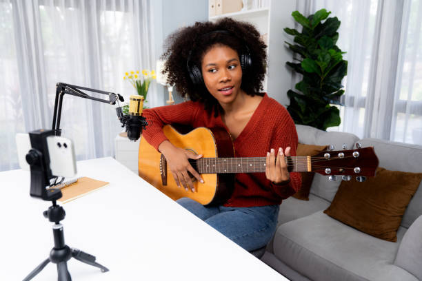 istock Host channel of African greeting on smartphone on broadcast studio. Tastemaker. 1980935872