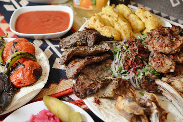 A table is adorned with multiple plates of food accompanied by a bowl of sauce.