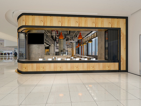 Wide angle shot of a bar counter and shelves of alcohol behind the bar.