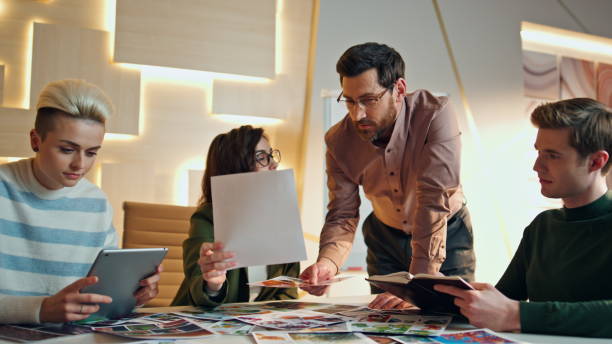 istock Business team working boardroom discussing design project. Group sharing ideas. 1980950557