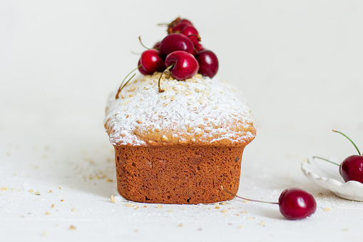 Homemade nut cake with cherrys on white background. Aesthetic breakfast concept.