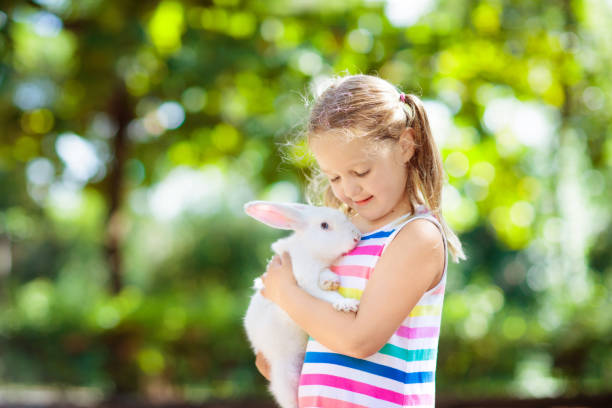 istock Child with rabbit. Easter bunny. Kids and pets. 1980960545