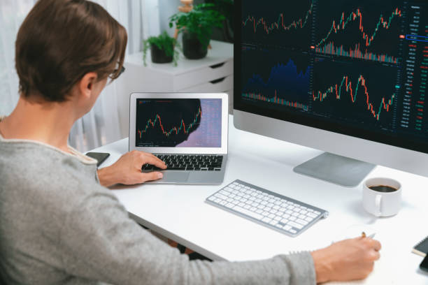 istock Business trader using computer and laptop to search high profit. Pecuniary. 1980966377