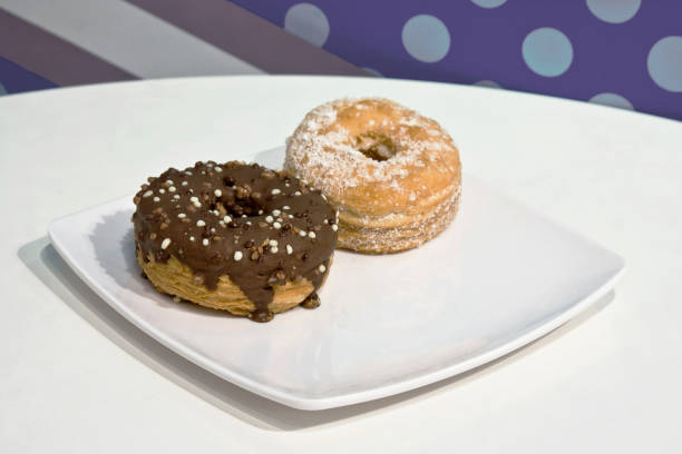 istock chocolate donut and sugar donut on a white plate, Crodots or donuts 1980969001