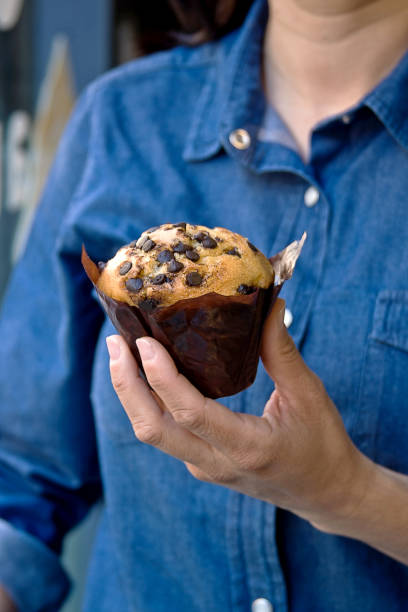 chocolate chip pancake held in a woman's hand