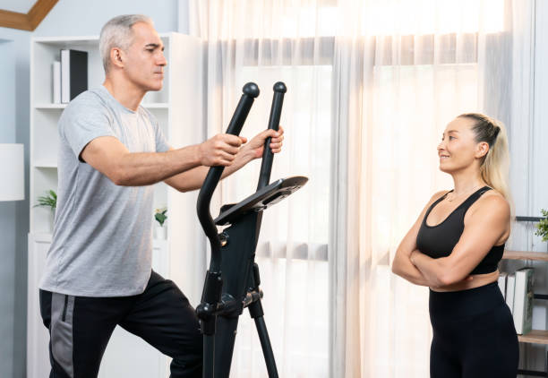 istock Active senior couple running on elliptical running machine. Clout 1981017897