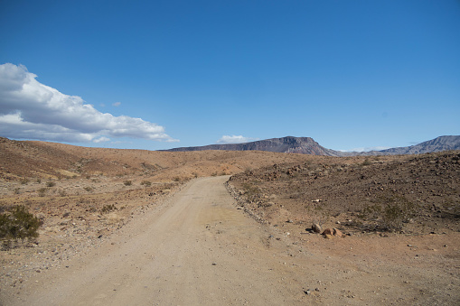 A sandy desert road leads through the Lake Mead National Recreation Area, Nevada